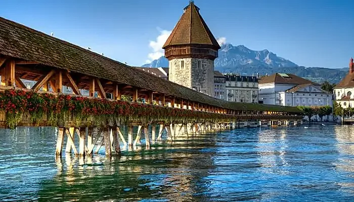 The Chapel Bridge made of wood in Lucerne is one of the major Switzerland tourist attractions